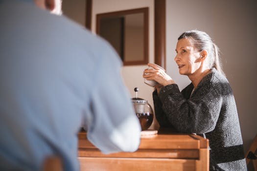 person smiling while studying with a cup of coffee